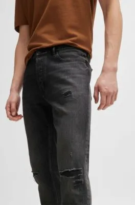 Vaqueros tapered fit en denim desgastado negro
