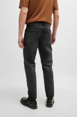 Vaqueros tapered fit en denim desgastado negro